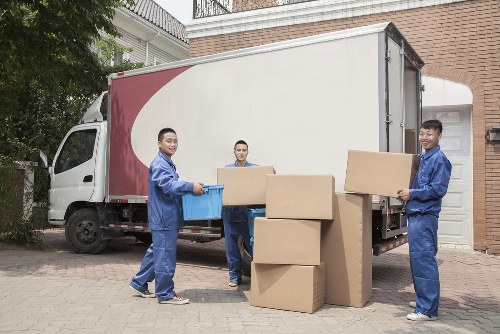 Removal team handling household items in North Kensington street setting