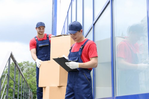 Moving team preparing a North Kensington home relocation with boxes and furniture