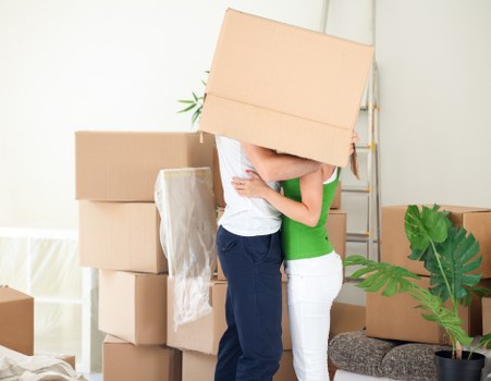 Packed moving boxes and furniture ready for local removal transport