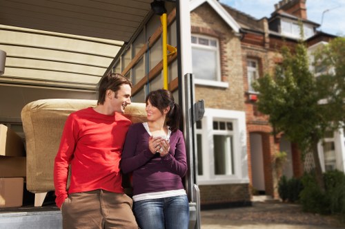 Loading furniture and boxes into a removals truck in North Kensington
